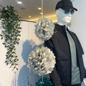 Dekoriertes Schaufenster mit Herrenbekleidung der Marke On im On Shop Serfaus